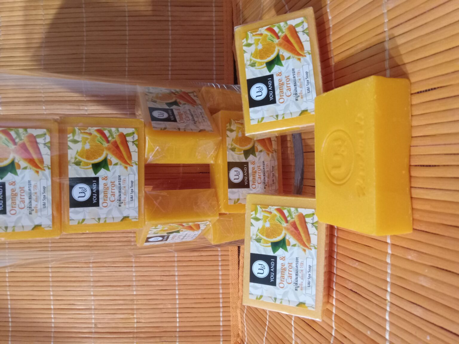 A stack of three bars of soap with orange and lemon.