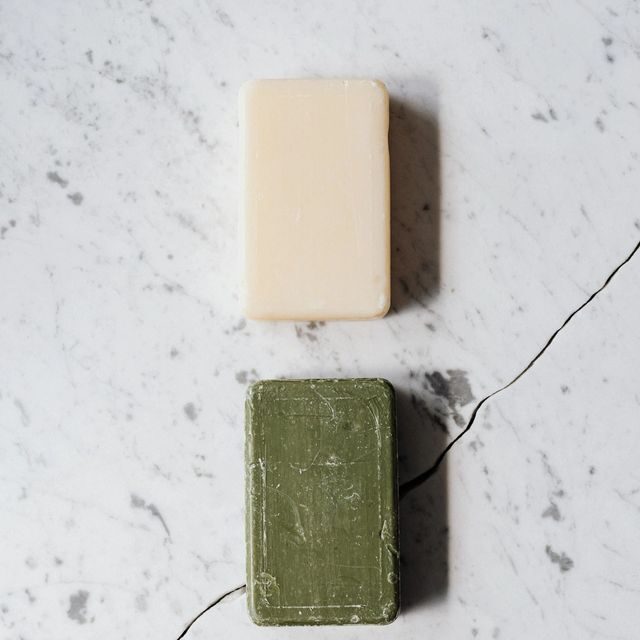 Two bars of soap sitting on top of a counter.